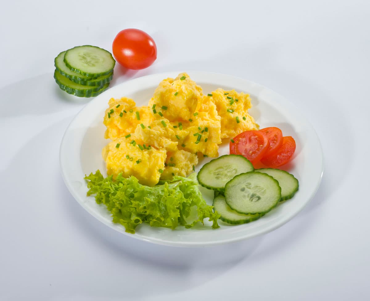 Scrambled eggs with tomato and cucumber